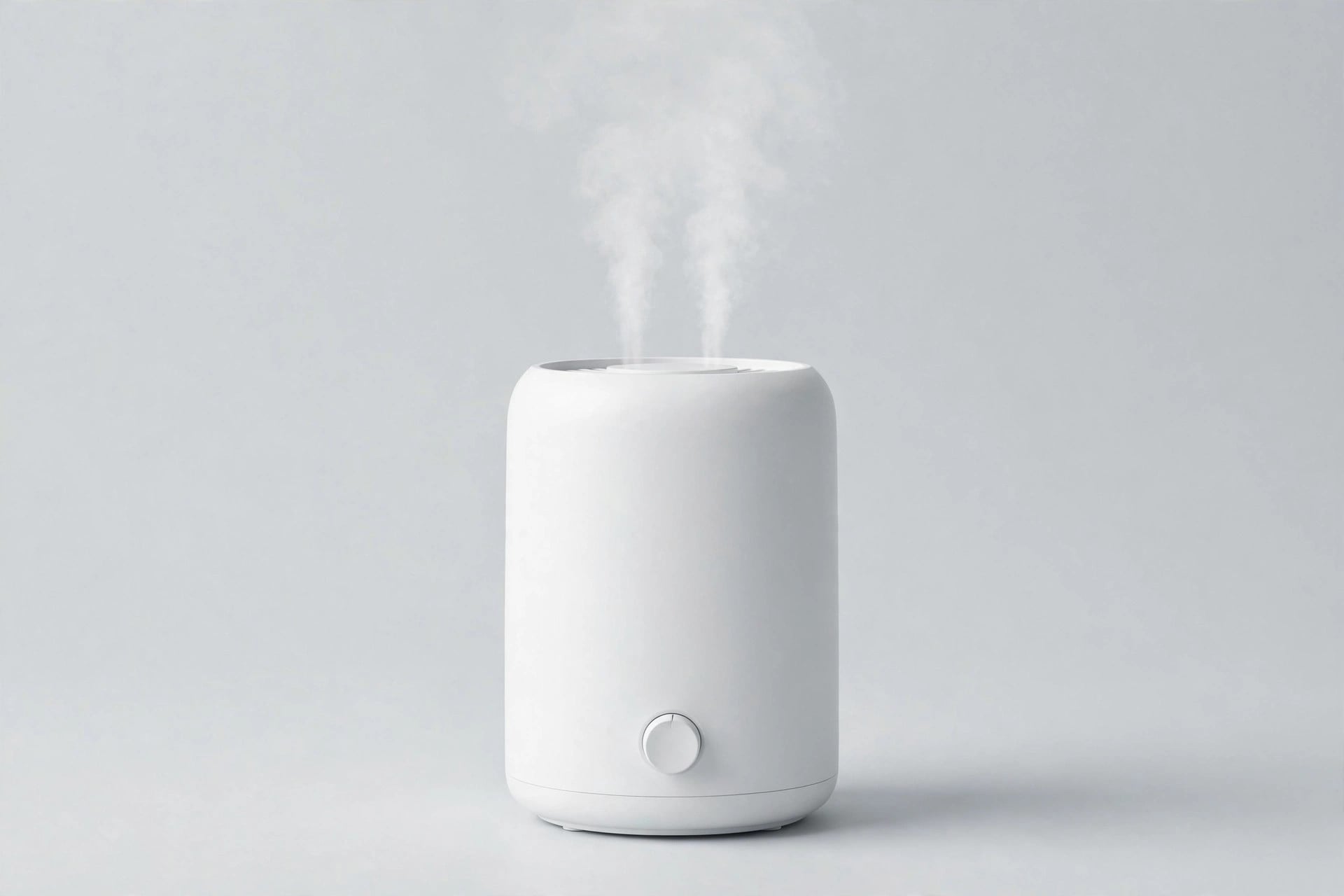 White generic humidifier with mist on a light-gray studio background